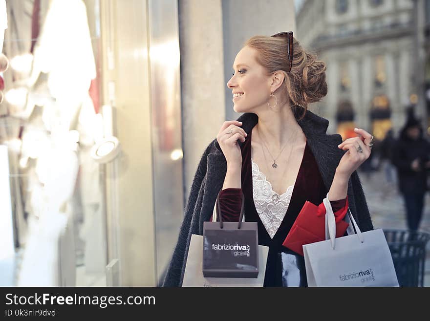 Woman Wearing Black Blazer Holding Shopping Bags