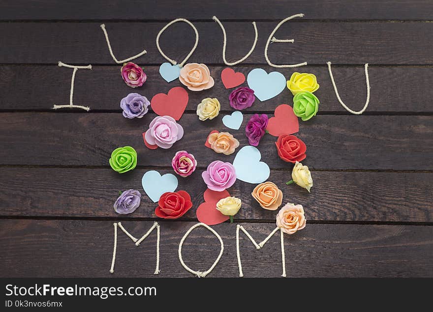 Forming the word: i love MOM on background