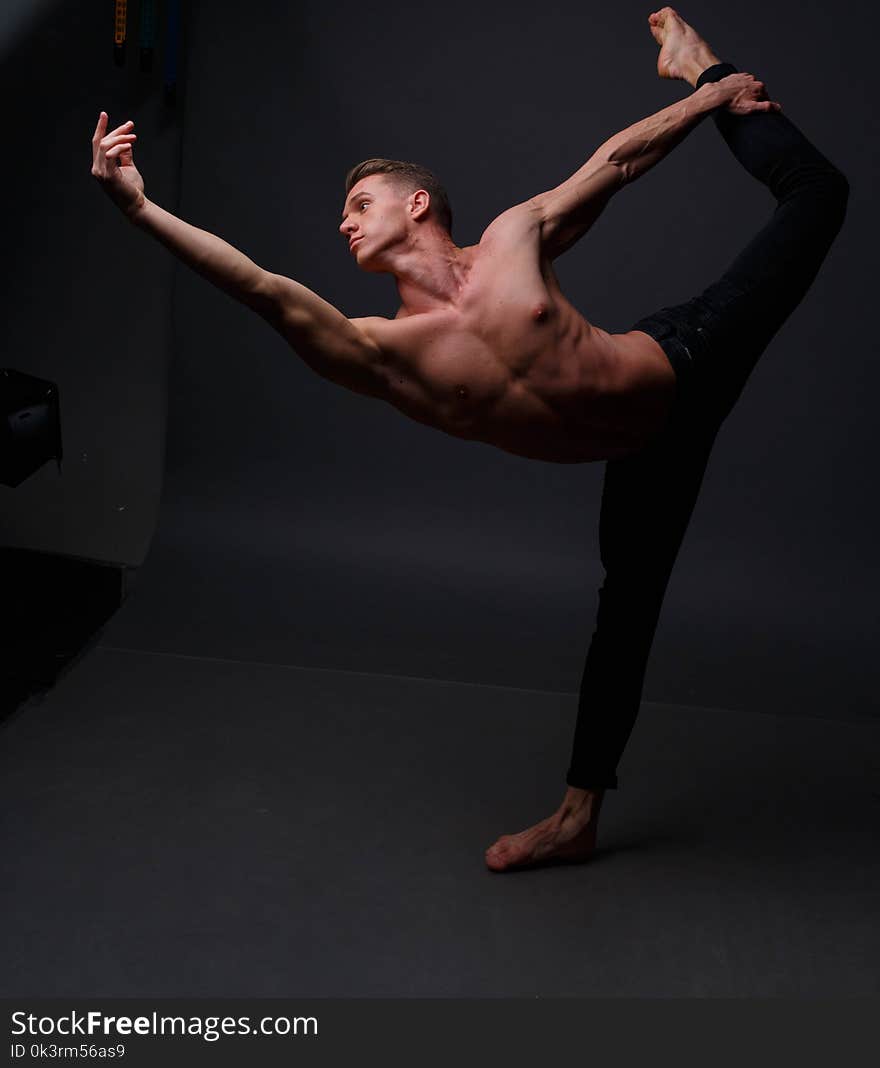 white man in an unbuttoned black shirt and black shorts dancing on a gray background, bare legs and torso, studio shot. white man in an unbuttoned black shirt and black shorts dancing on a gray background, bare legs and torso, studio shot