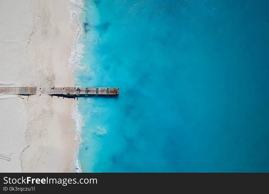 Drone photo of pier in Grace Bay, Providenciales, Turks and Caicos. The caribbean blue sea and white sandy beaches can be seen. Drone photo of pier in Grace Bay, Providenciales, Turks and Caicos. The caribbean blue sea and white sandy beaches can be seen
