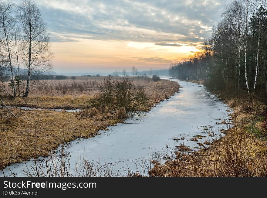 A frozen river with a beautiful sunrise. A frozen river with a beautiful sunrise.