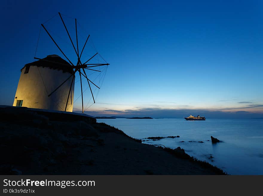 There is one wonderful windmill at dusk on the Mykonos island, Greece. The windmill locates nearby the coast.