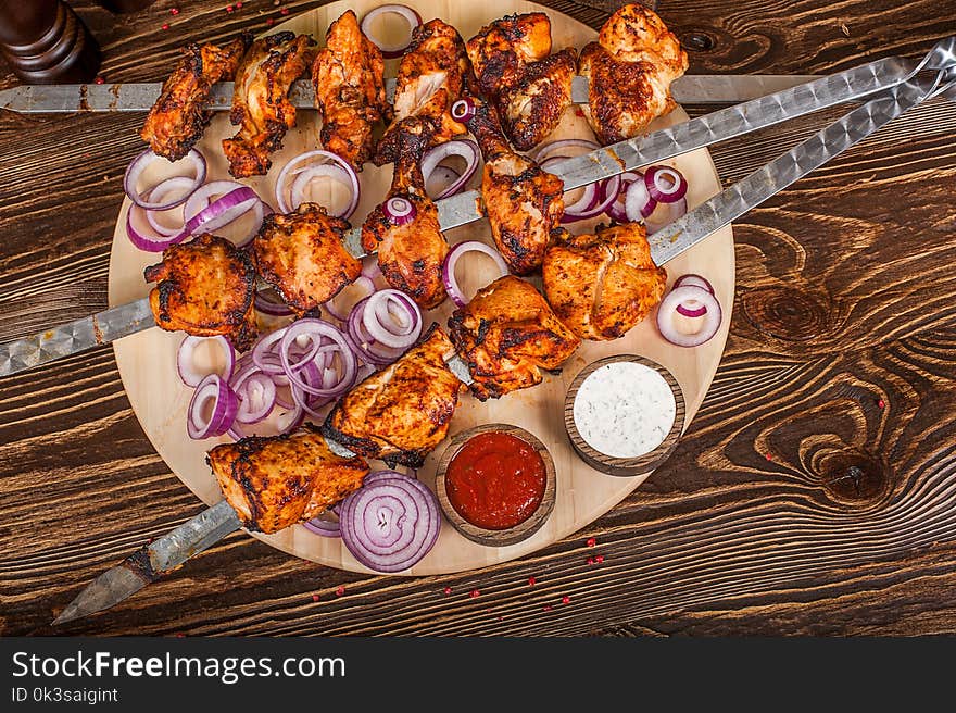 Barbecue shish kebabs - grilled meat on wooden background. Barbecue shish kebabs - grilled meat on wooden background