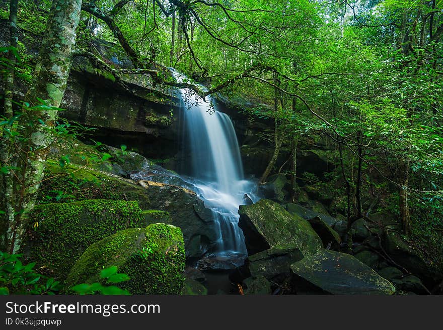 Landscape of peaceful waterfall with green moss in the tropical rainforest, waterfall in Phu Kradueng National Park, Loei Province, Thailand. Landscape of peaceful waterfall with green moss in the tropical rainforest, waterfall in Phu Kradueng National Park, Loei Province, Thailand