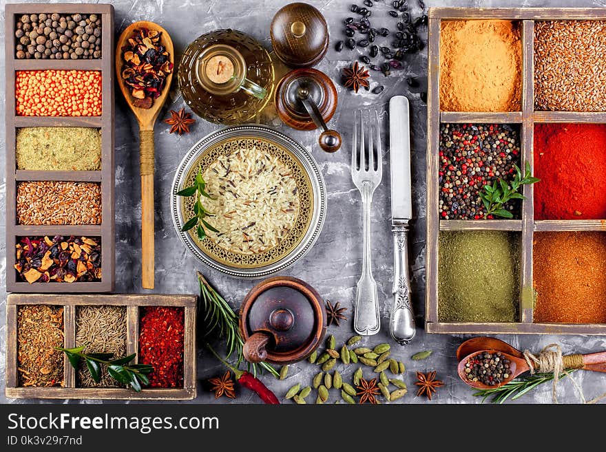 Spices for cooking with kitchen accessories on an old background