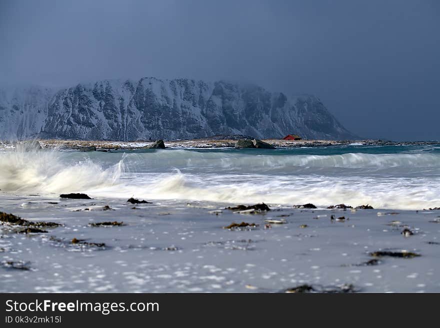 Storm waves on the beach in Lofoten Archipelago, Norway in the winter time