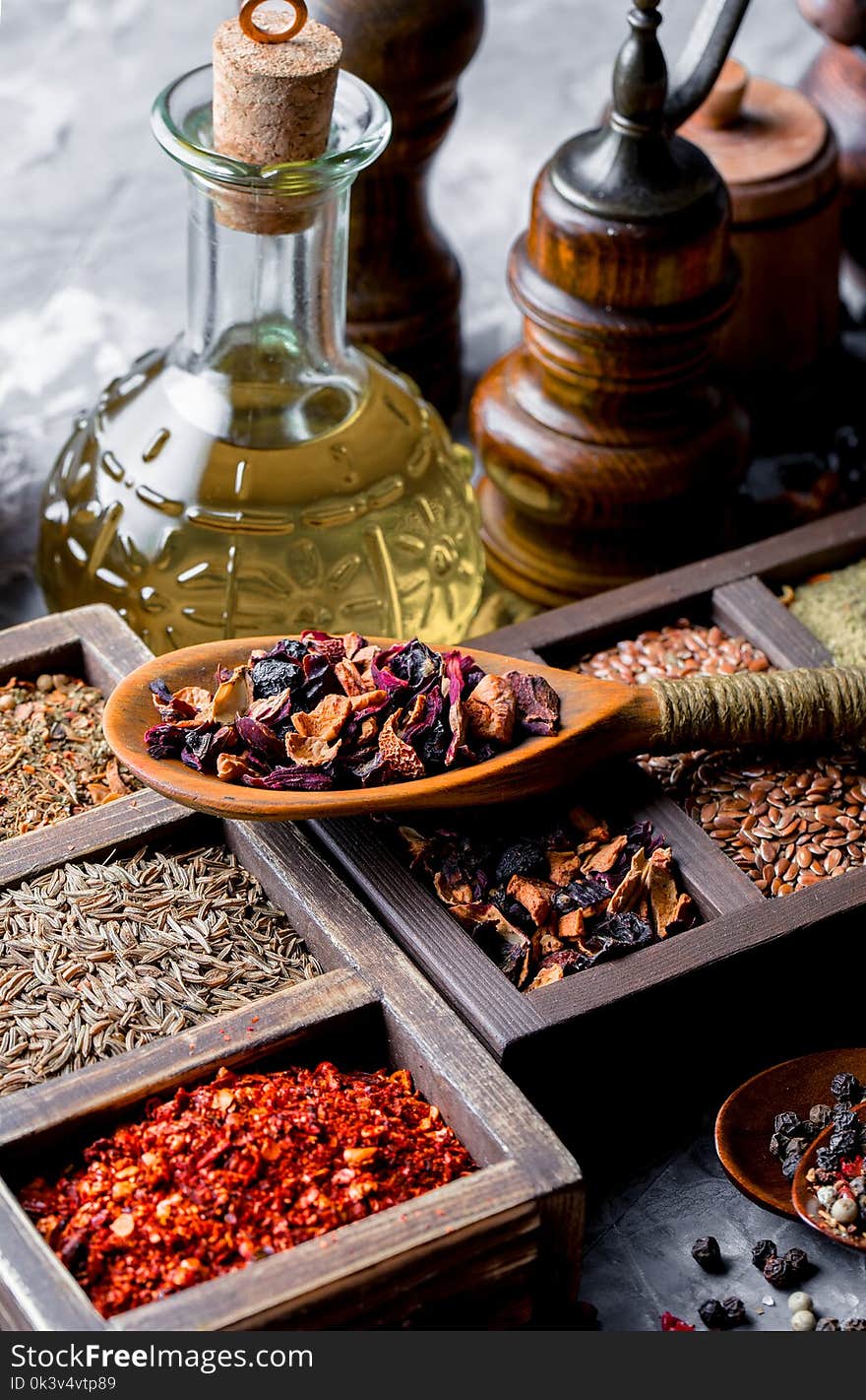 Spices for cooking with kitchen accessories on an old background