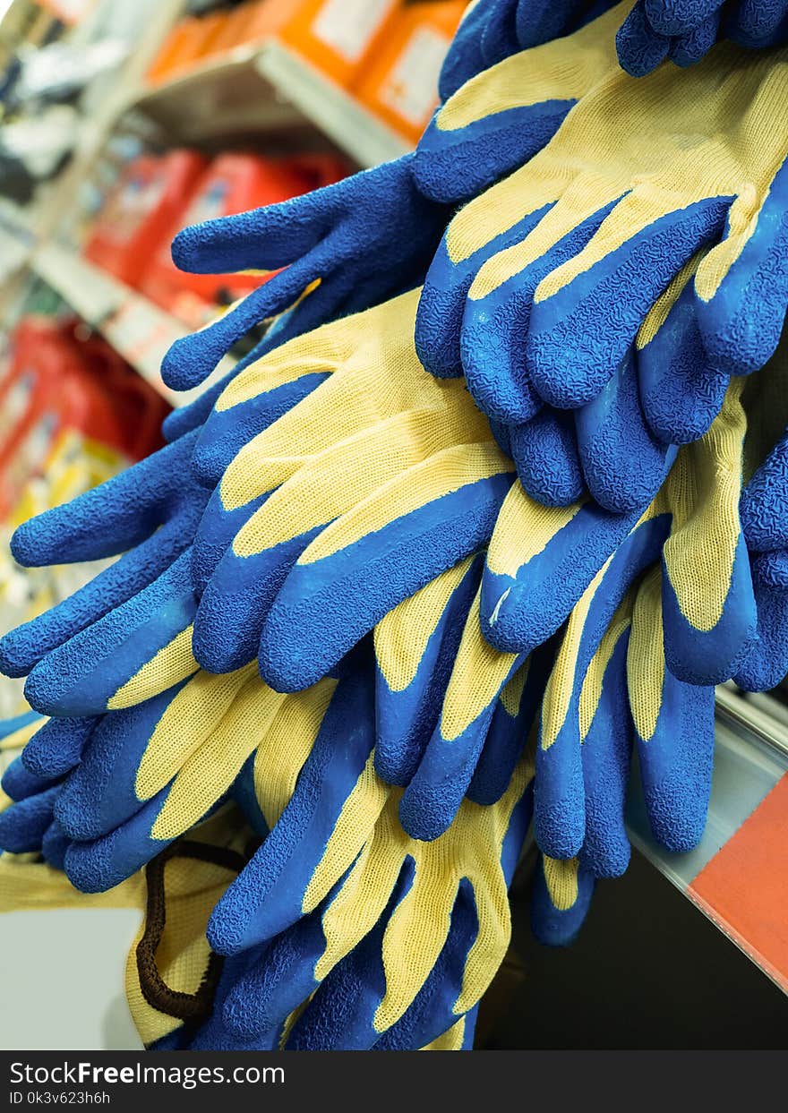 New Colored Work Gloves On The Shelf Of The Store