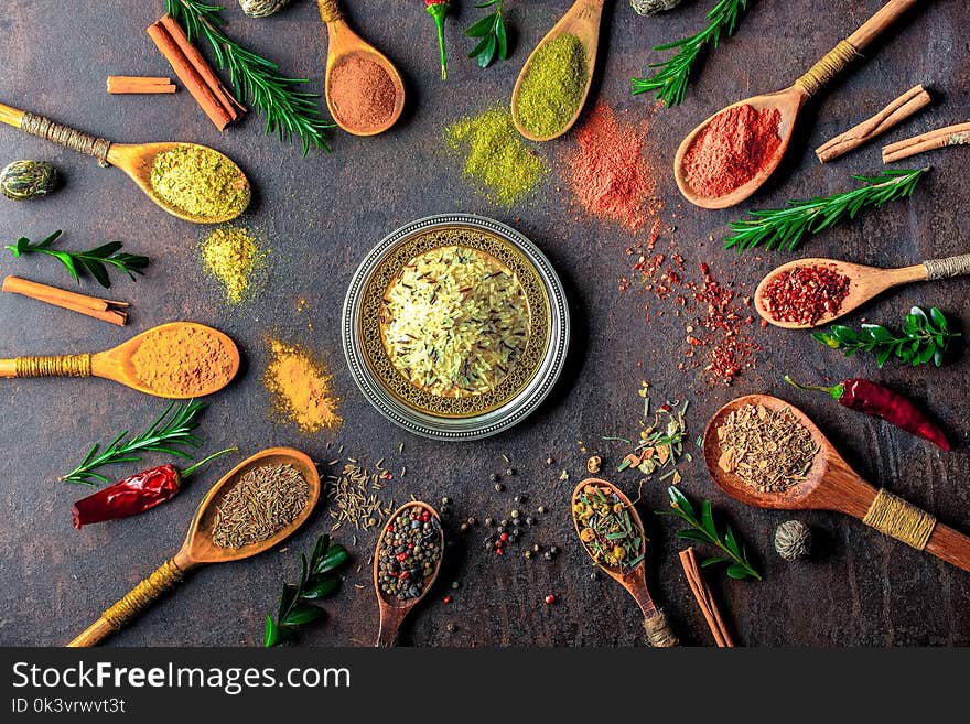 Spices for cooking with kitchen accessories on an old background