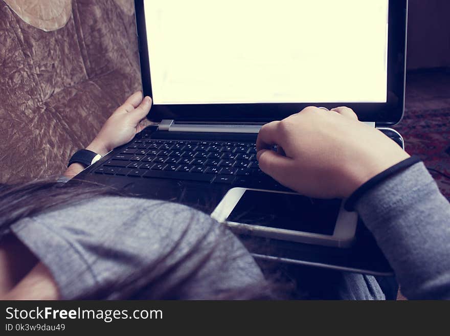 Girl Sitting On The Couch And Working With Laptop