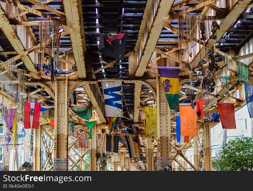 Assorted Flags Under Steel Train Rail