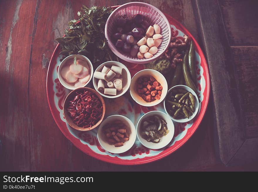 Assorted Spices on White and Red Plate on Brown Wooden Table