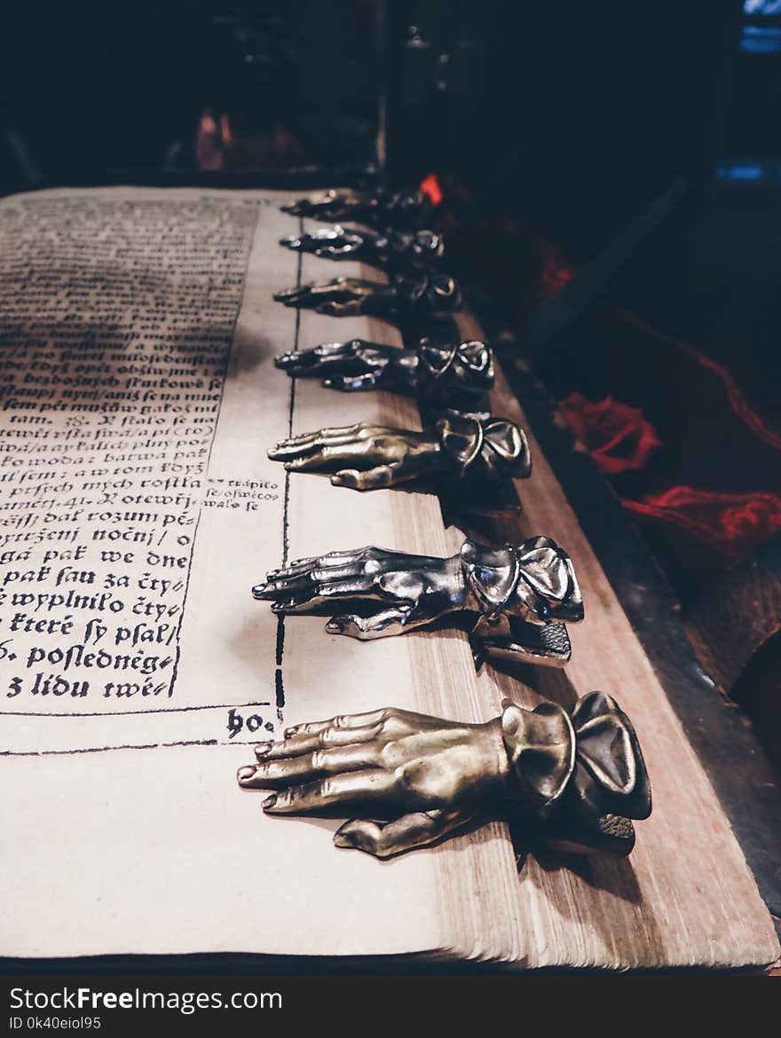 Close Up Photo of Black and Brown Metal Hand Book Mark