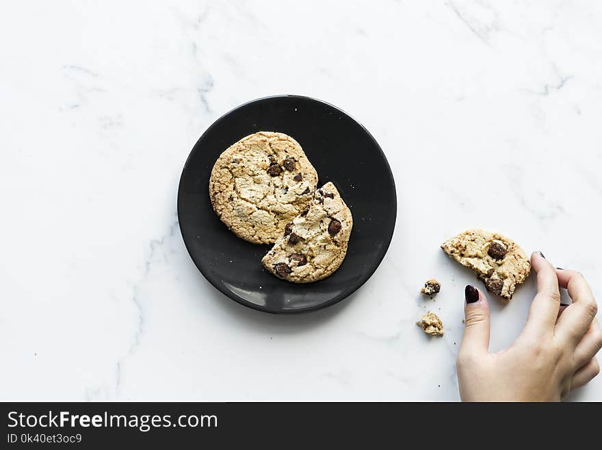 Two Cookies on Black Ceramic Plate