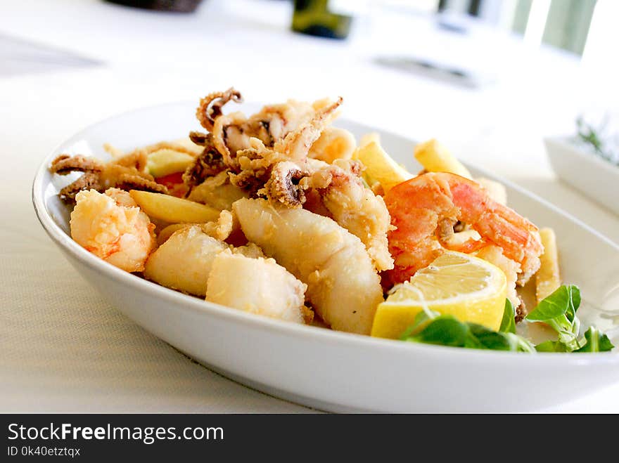 Deep Fried Shrimp and Squid With Slice of Lemon on Ceramic Plate