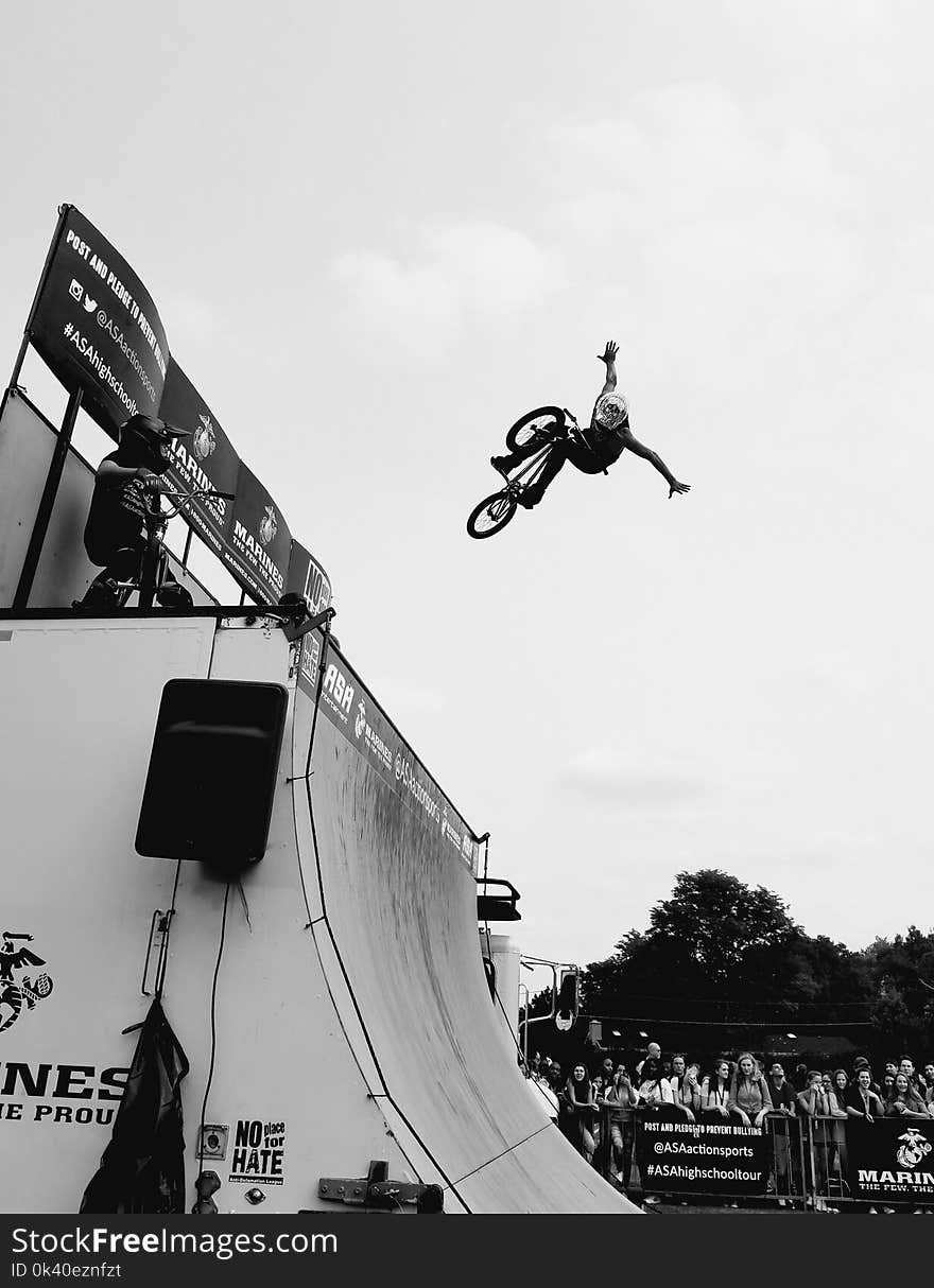 Grayscale Photo of Bmx Rider on Tournament