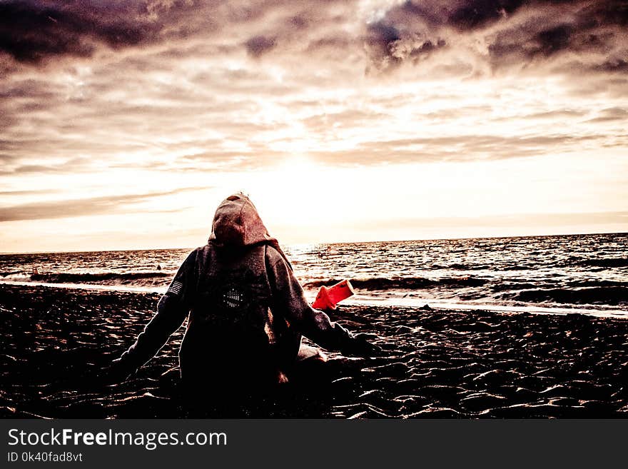 Person Sitting on Shore