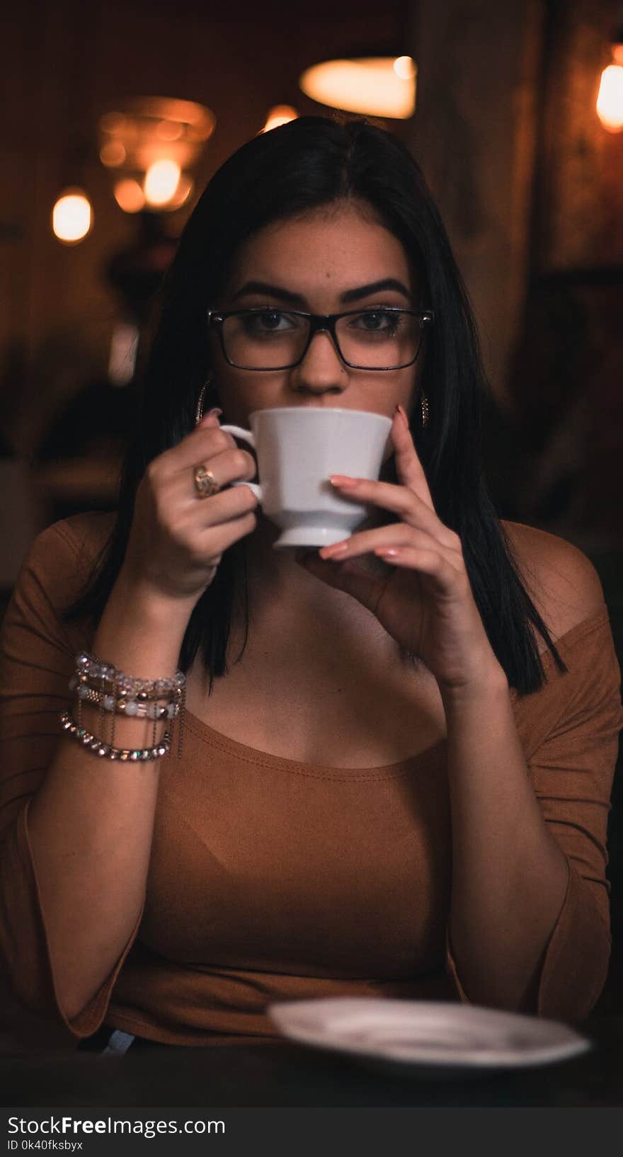 Woman Wearing Brown Scoop-neck Quarter-sleeved Top Holding White Ceramic Mug