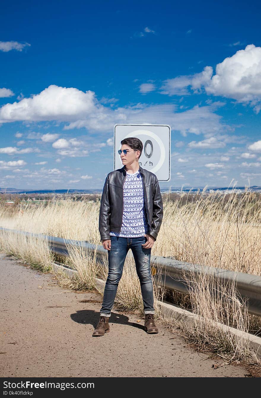 Man in Black Leather Zip-up Jacket and Black Jeans Wearing Black Sunglasses