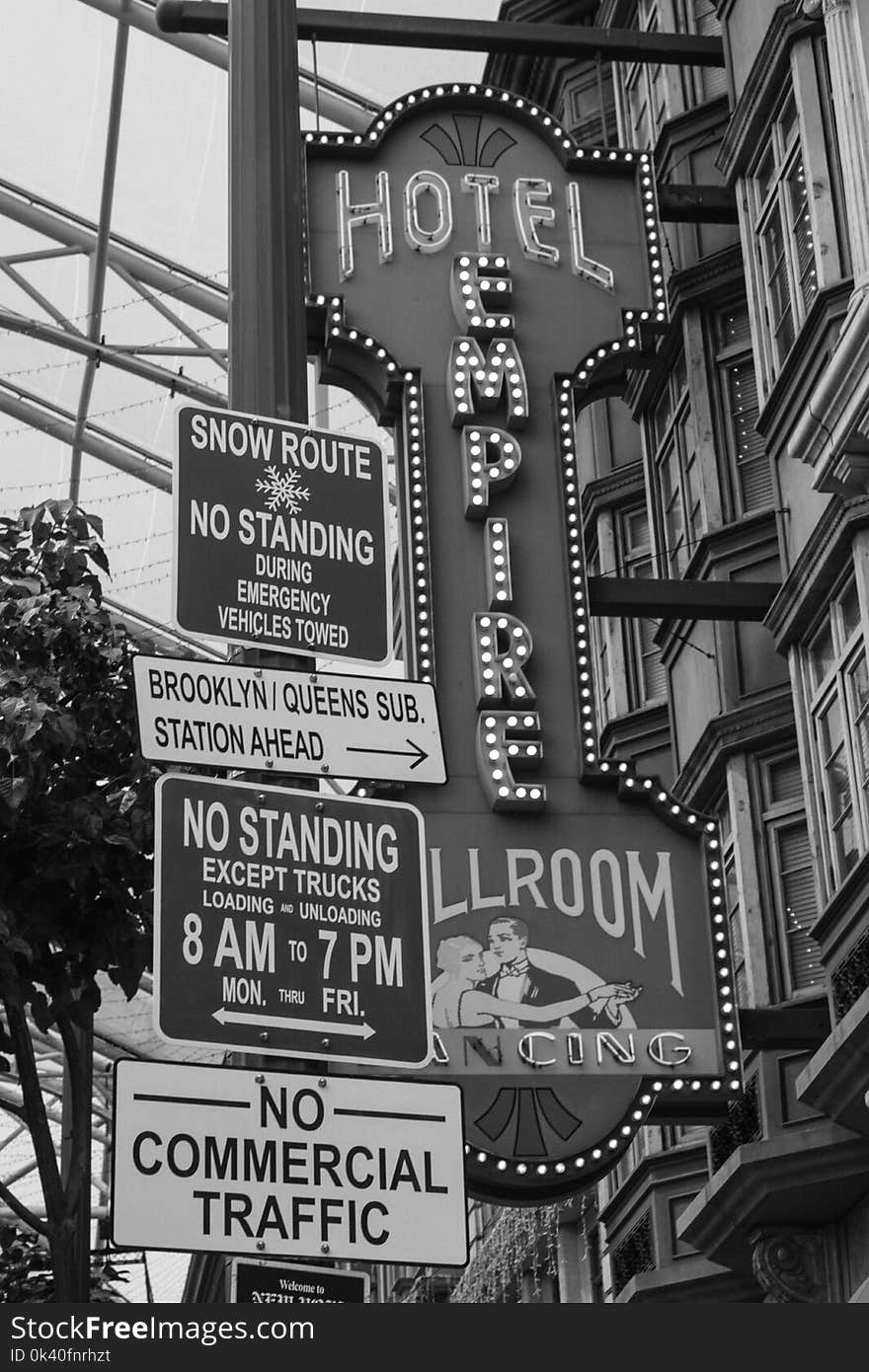 Grayscale Photo of Hotel Empire Signage