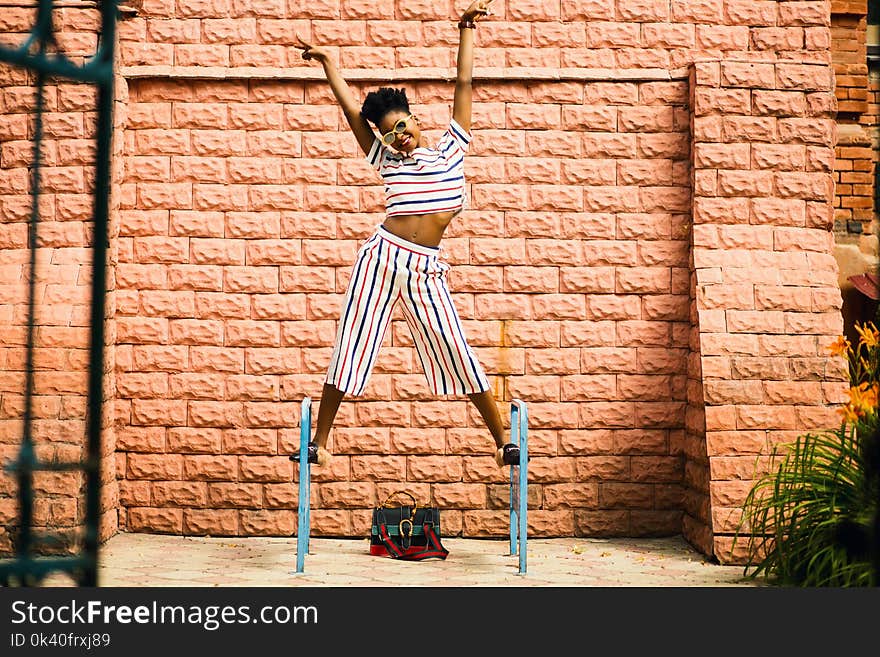 Woman in White-red-and-blue Striped Pants and Top