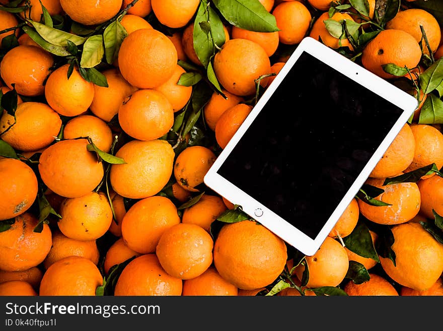 Photo of Ipad on Orange Fruits