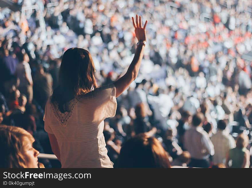 Woman With White Shirt Raising Her Right Hand