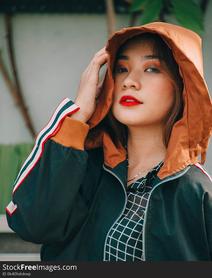 Closeup Photography of Woman Wearing Black and Brown Zip-up Hoodie