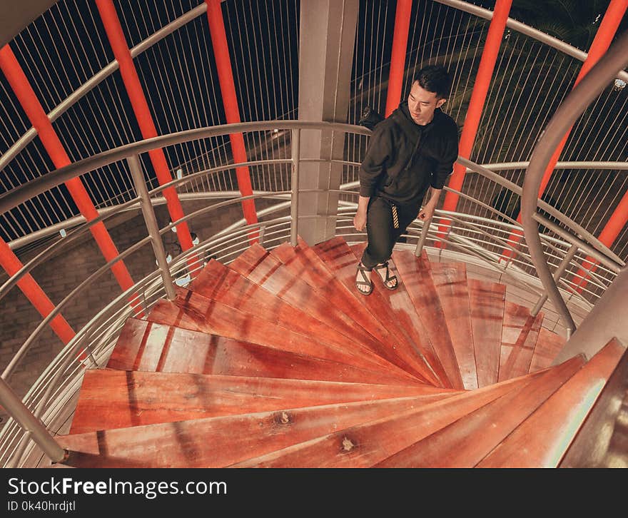 Man Wearing Black Hoodie Standing on Staircase