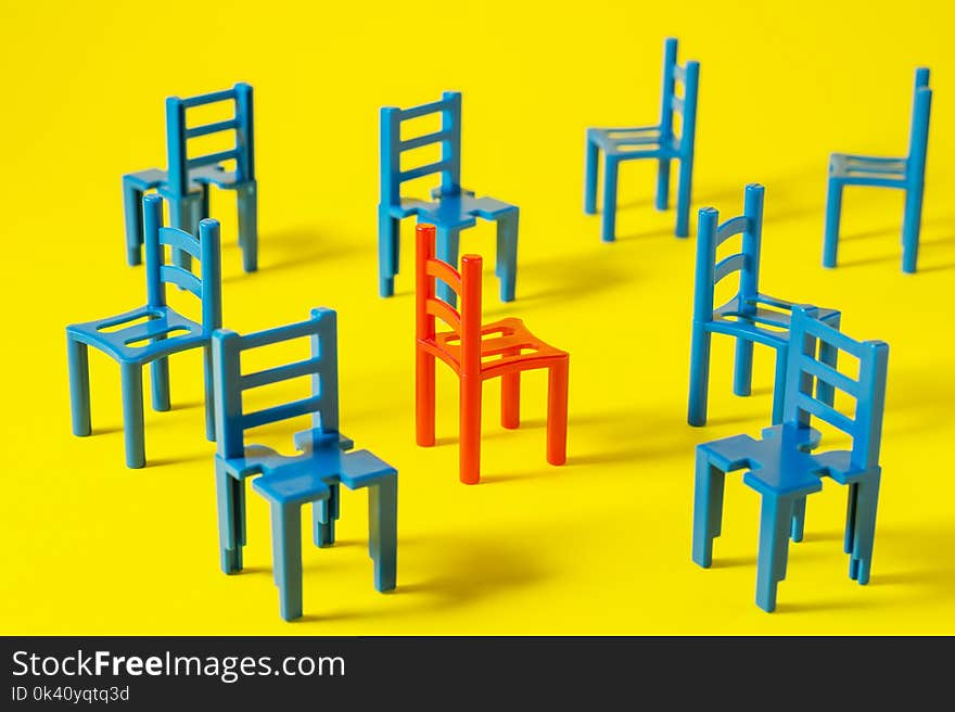 Unique red chair in a group blue others.