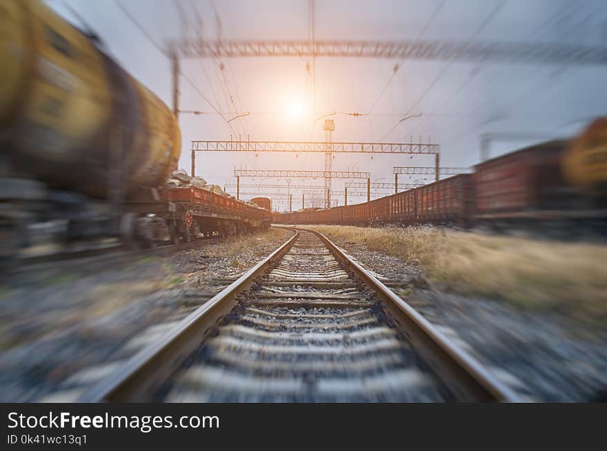 Tanks with gas or oil transportation by railroad at sunset