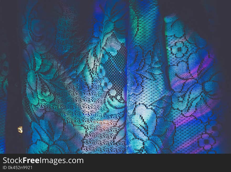 Defocused colorful garland lights reflection on white curtains background. Defocused colorful garland lights reflection on white curtains background.