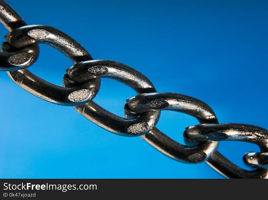 Metal chain close-up on a blue background