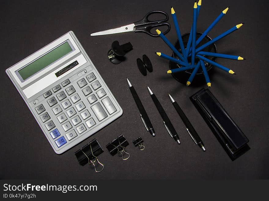 Black stationery on a black background. View from above. Stationery on a black background.