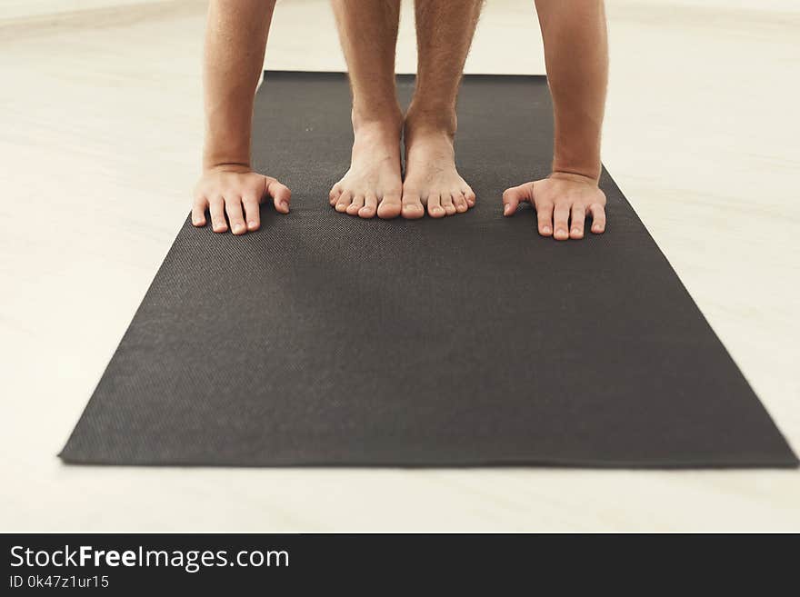 Man standing on his mat, training yoga, closeup. Fitness, meditation concept, copy space. Man standing on his mat, training yoga, closeup. Fitness, meditation concept, copy space