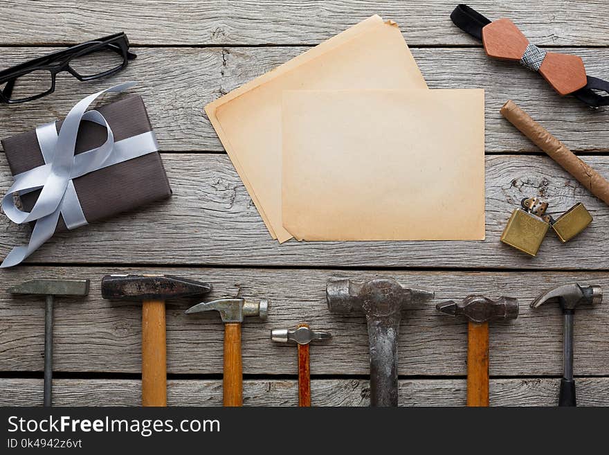 Happy Fathers Day background, card with repair tools, hammers and other man things on rustic wood, top view, copy space on craft paper