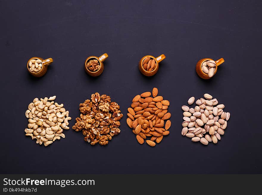 Assortment of nuts on a black background - healthy snack. Top view. Copy space