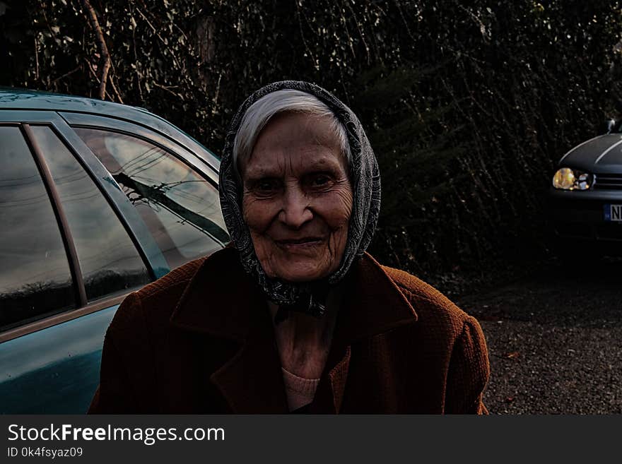 Woman Wearing Brown Jacket and Black Head Scarf