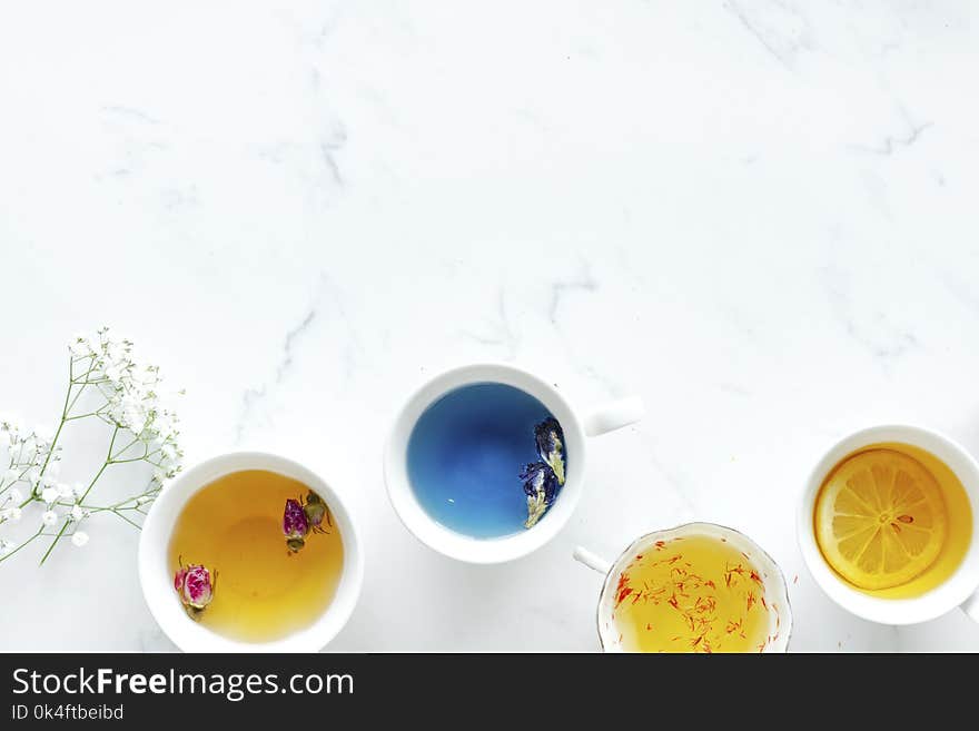 Four Ceramic Teacups Filled With Teas