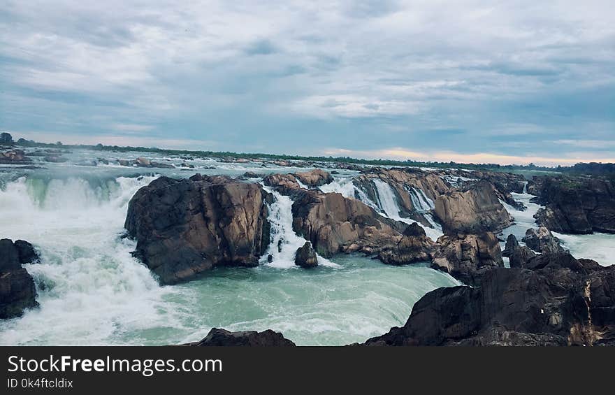 Landscape Photography of Rocks on Body of Water