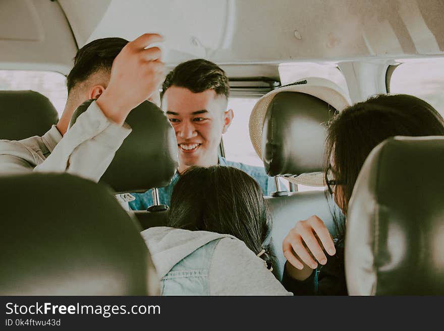 Shallow Photography of Man in Green Top Inside Vehicle