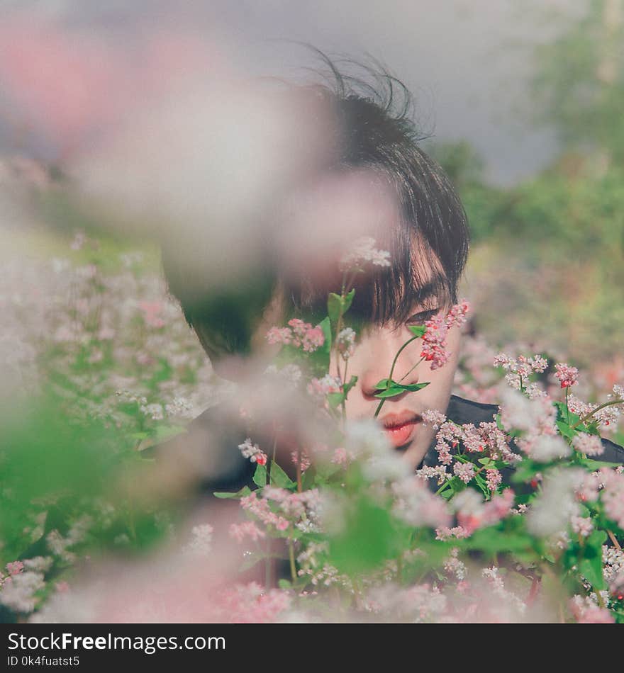 Photography of A Man Near Flowers