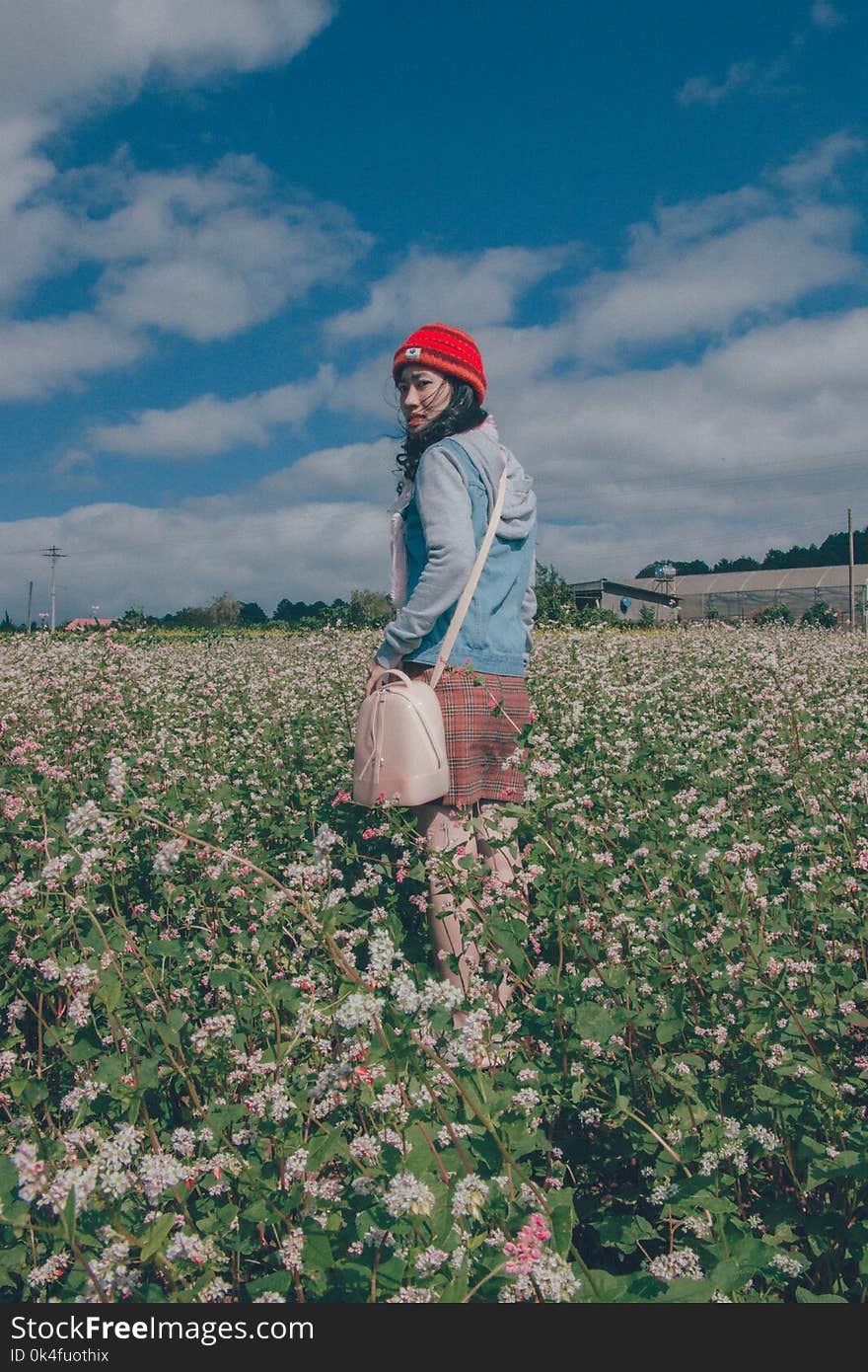 Woman Wearing Red Knit Hat and Blue Hoodie Jacket