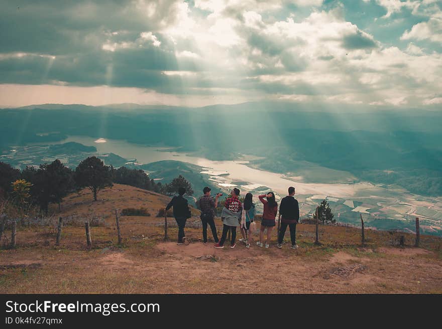 Group of People Standing Near Fence