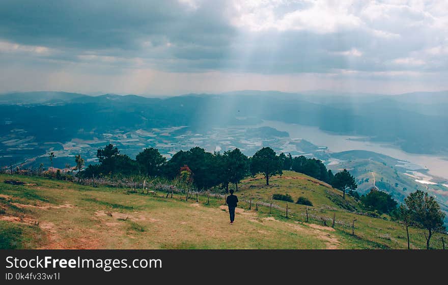 Photo of Man Walking inn the Field