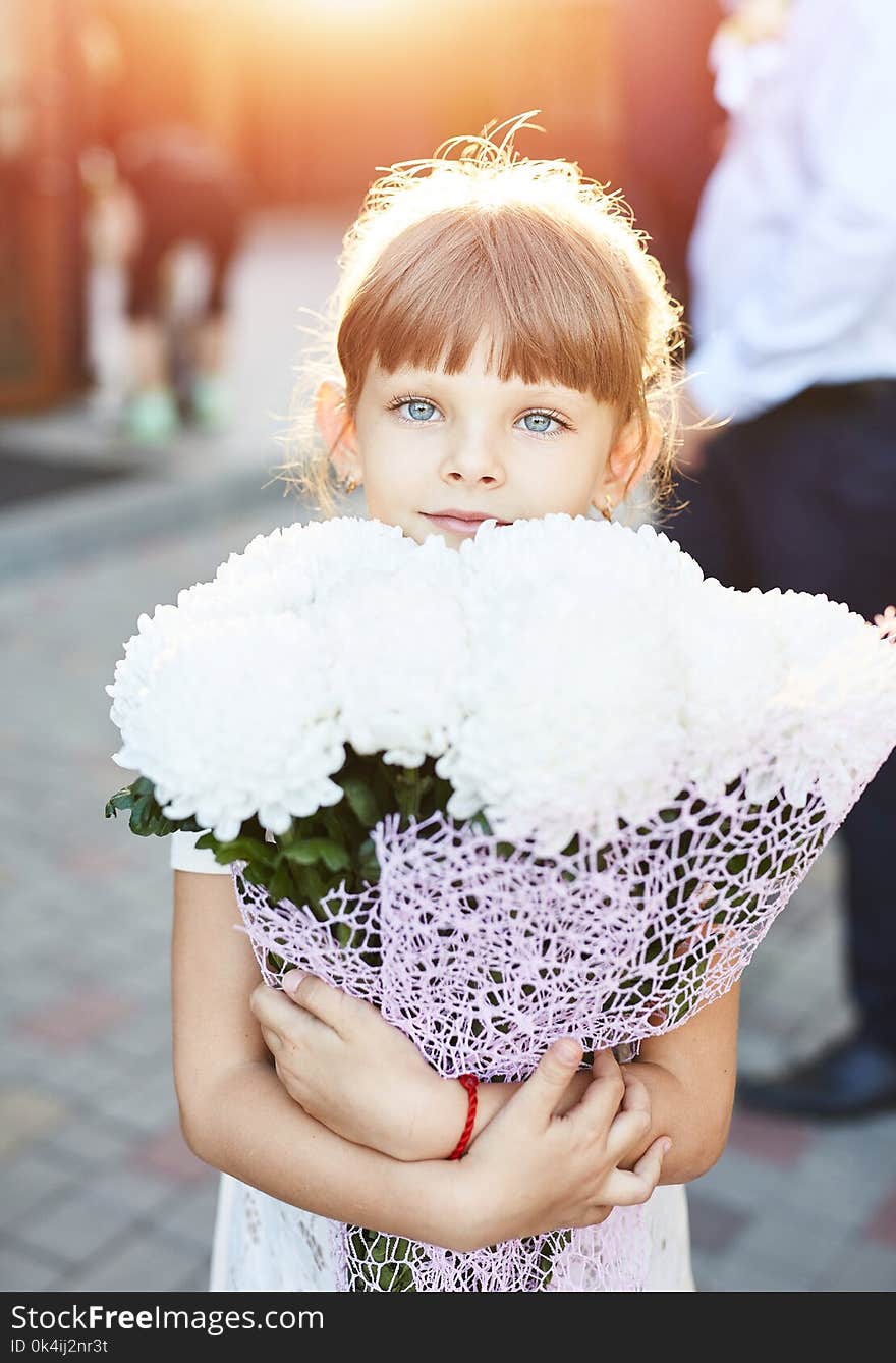 Little girl with a big bouquet of flowers