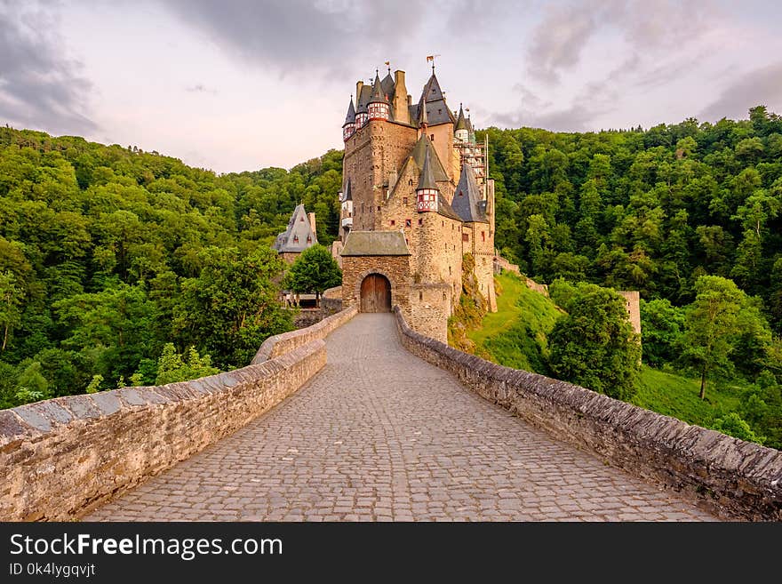 Burg Eltz castle in Rhineland-Palatinate state at sunset, Germany. Construction started	prior to 1157. Burg Eltz castle in Rhineland-Palatinate state at sunset, Germany. Construction started	prior to 1157.