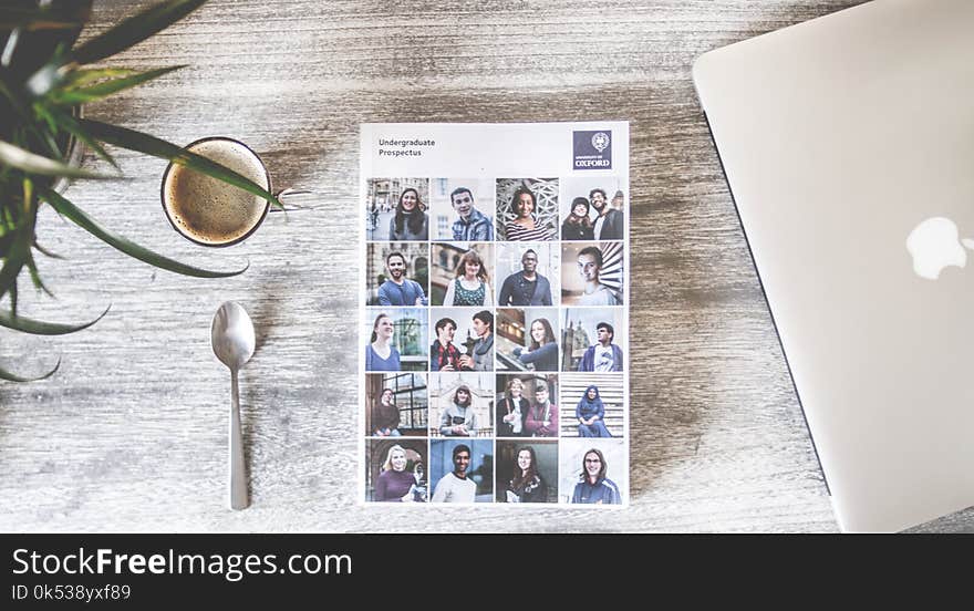 Flat Lay Photography of Cup, Spoon, Macbook and Book