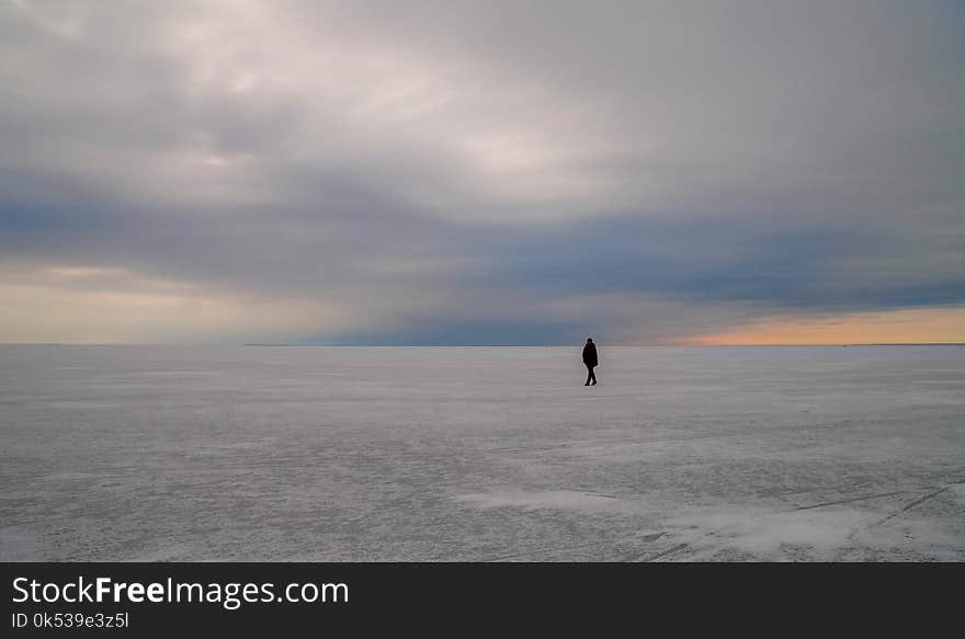 Silhouette of Person Walking on Vast Land