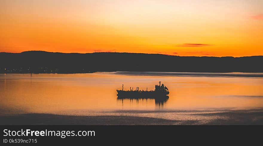 Silhouette Photography of Mountain and Body of Water